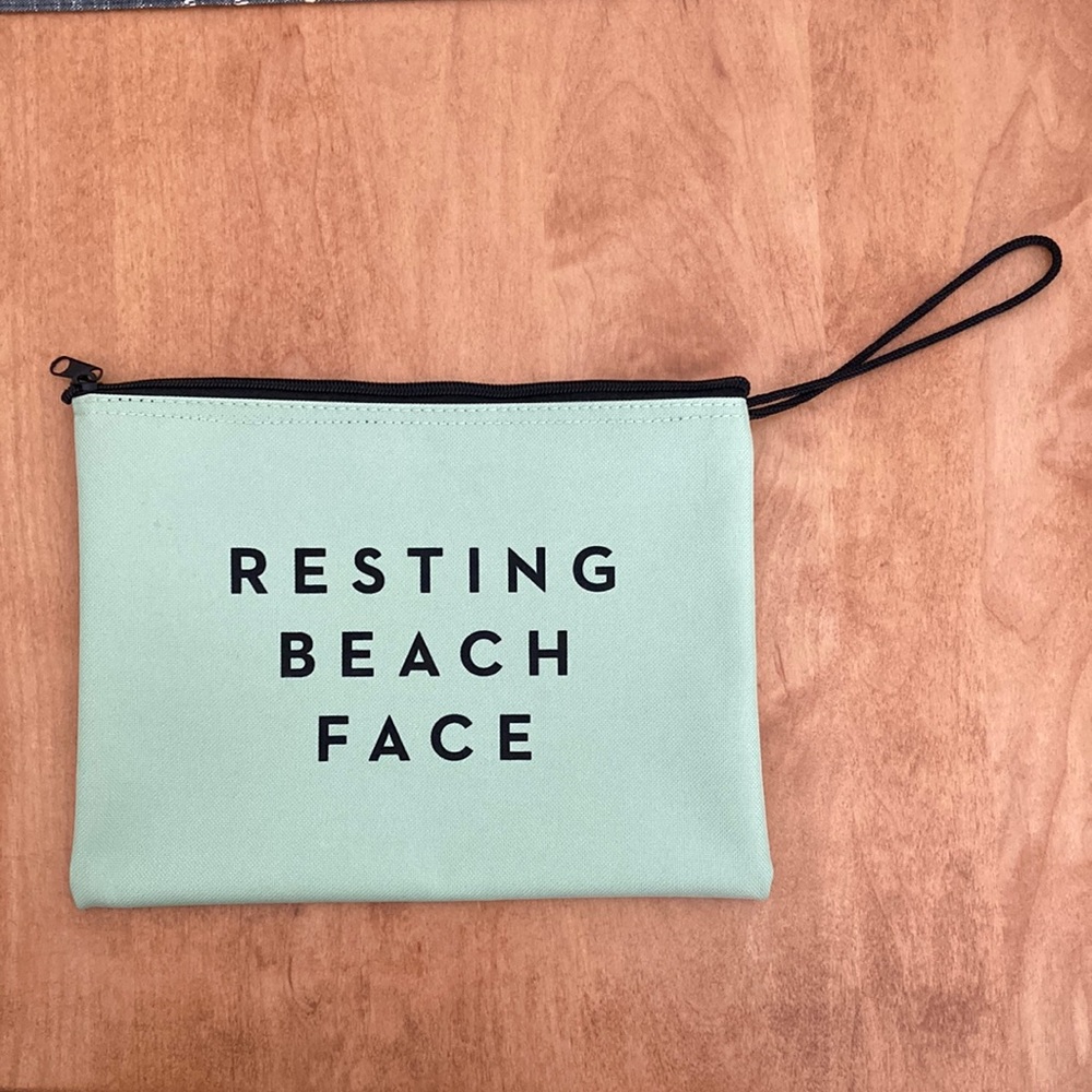 Mint green zip top bag w black loop handle.